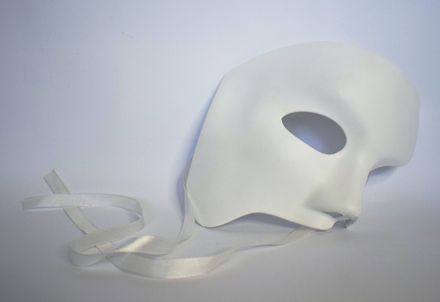 Masque de visage blanc posé sur un fond blanc