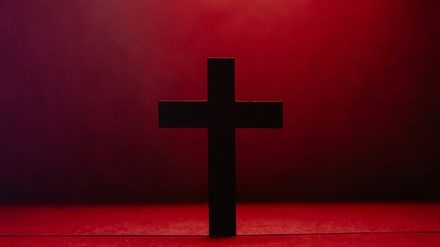 Croix sombre sur fond rouge sang